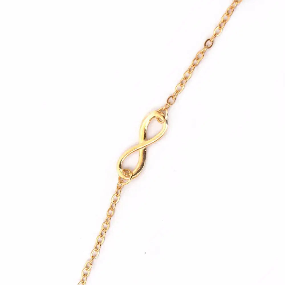 Close-up of gold plated infinity symbol charm on 925 sterling silver bracelet — UNJELLIC