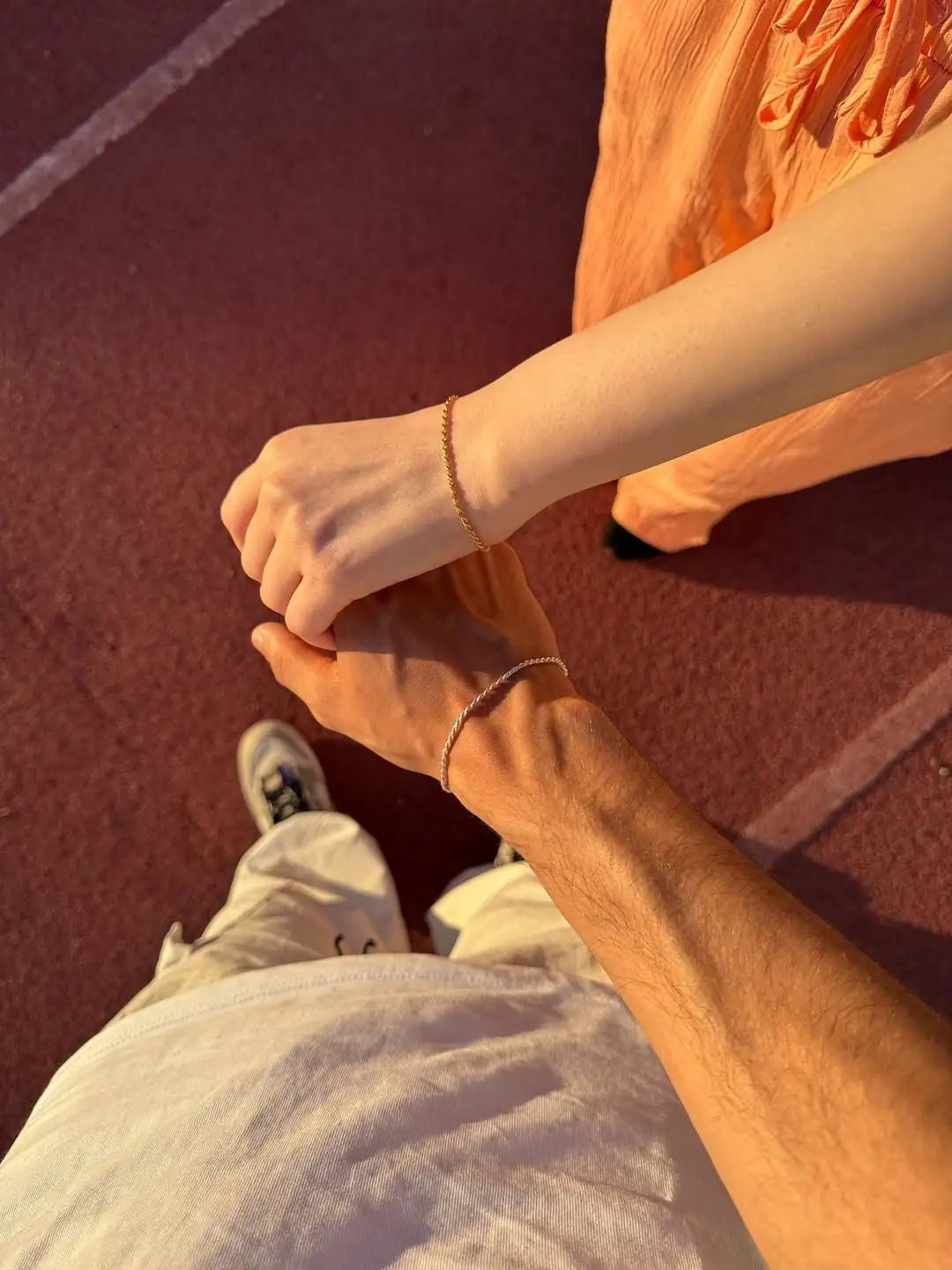 Couple wearing The Tether Set minimal 925 silver bracelets — his and hers slim chain bracelet set