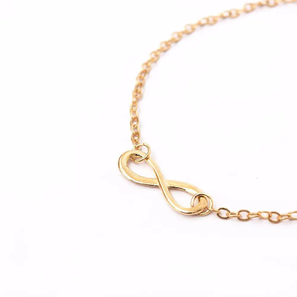 Gold infinity bracelet worn on woman's wrist — 18K gold plated 925 sterling silver, everyday jewellery India
