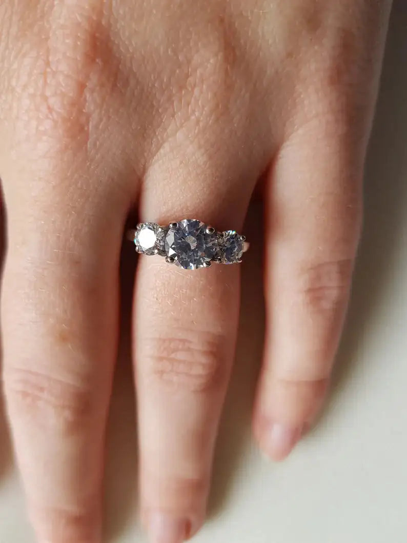 Triple stone 925 silver ring worn on finger — past present future CZ engagement ring for women