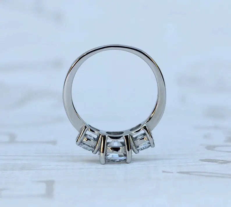 Close-up of triple stone 925 silver ring — three brilliant white cubic zirconia stones in a row